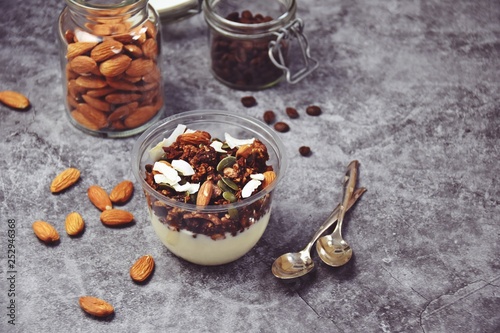 Chocolate and coffee yogurt granola in a plastic jar. Granola dessert for take away. Healthy street food granola  