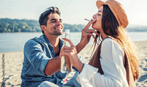 Beautiful young couple having fun on the beach. Lifestyle, love, dating, vacation concept