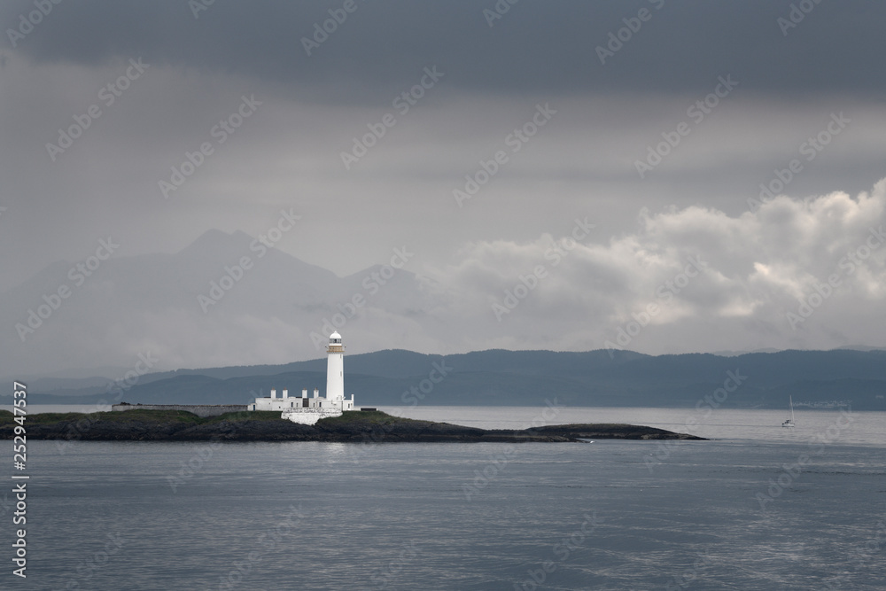 Lismore Lighthouse on Eilean Musdile Islet off Lismore Island with rain and clouds over the west coast highlands Scotland UK Lismore Lighthouse on Eilean Musdile Islet off Lismore Island with rain and clouds over the west coast highlands Scotland UK