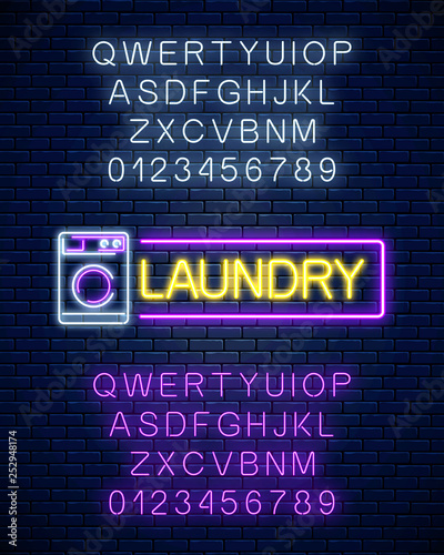 Glowing neon laundry signboard with alphabet. Illuminated self-service washhouse sign working round-the-clock.
