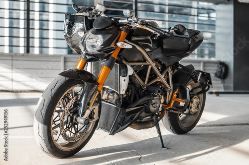 Close up of motorcycle on urban background at parking.