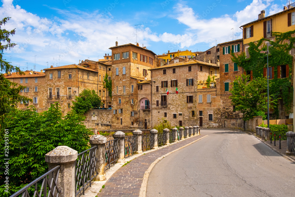 Perugia, Italy - Panoramic view of the Perugia historic quarter with medieval houses and ancient aqueduct valley along the Via Cesare Battisti street