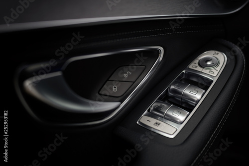 Window open close control button in car. Interior details. Macro.
