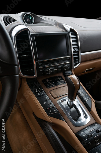 Panel of a modern luxury car. Screen multimedia system and automatic transmission.
