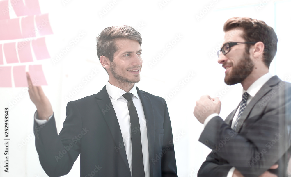 two employees discuss the business objectives two employees discuss the business objectives