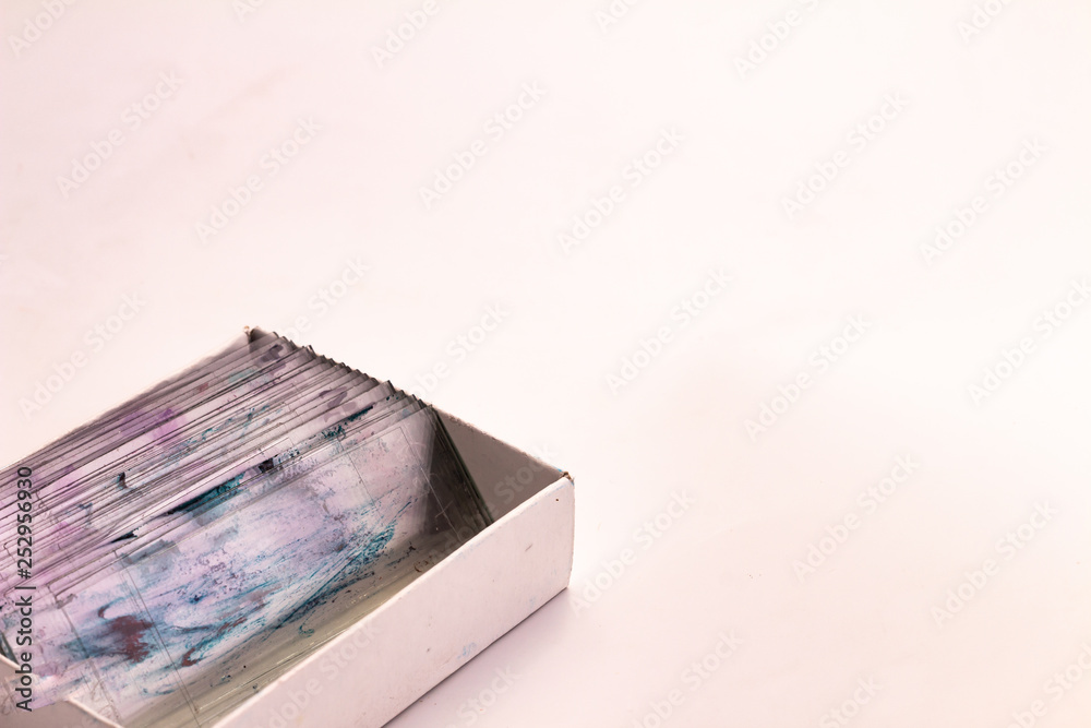 Small glasses with pieces of histological biopsies in a box on white background. Small glasses with pieces of histological biopsies in a box on white background.