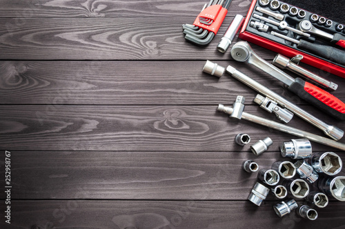 set of auto tools on dark wooden workbench. copy space