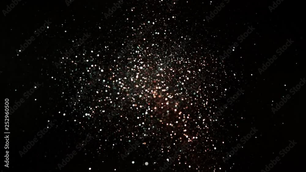 Red and silver glitter explosion in super slow motion on black background. Red and silver glitter explosion in super slow motion on black background.