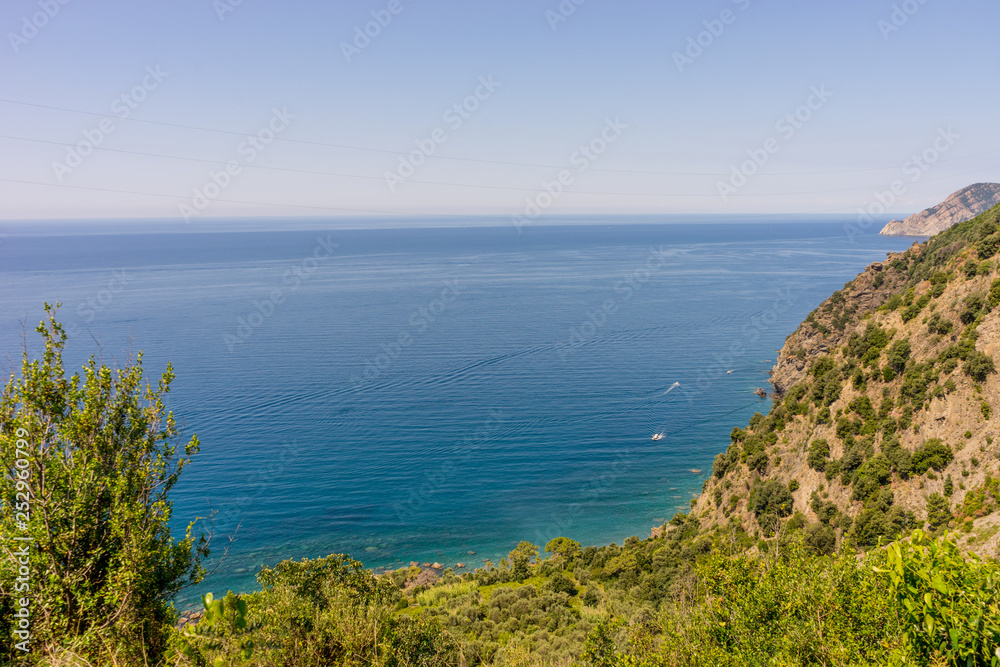 Italy, Cinque Terre, Corniglia, a close up of a hillside next to a body of water