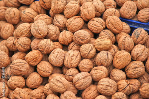 walnuts lie in a pile, natural harvest background