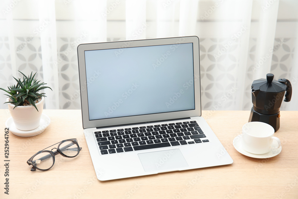 Cozy blogger workplace with laptop at home Cozy blogger workplace with laptop at home