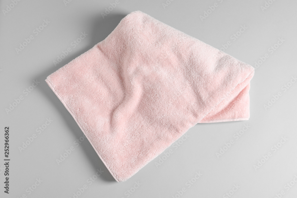Soft folded towel on light background, top view Soft folded towel on light background, top view