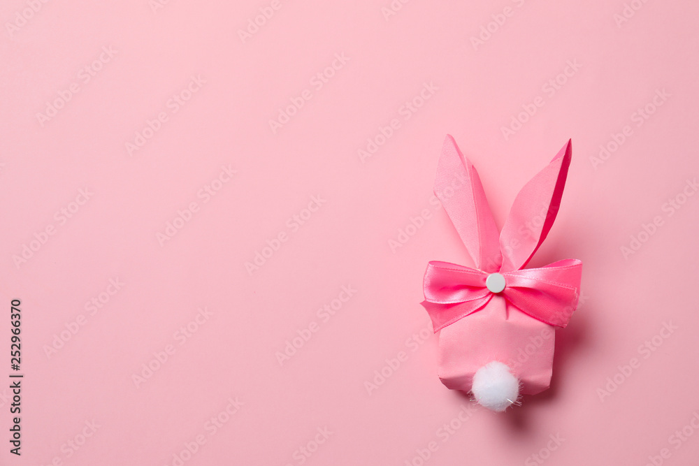 Creative Easter bunny gift bag on color background, top view with space for text Creative Easter bunny gift bag on color background, top view with space for text