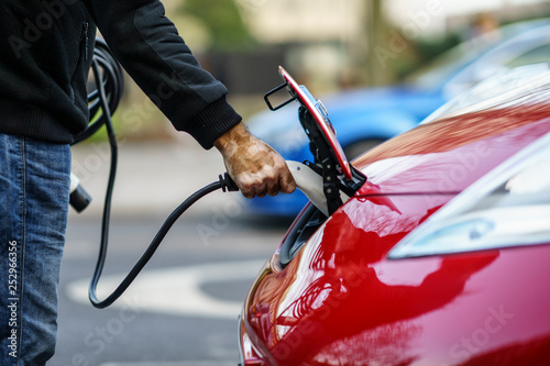 Owner of electric car plugged the charger of the car in City Centre of Coventry