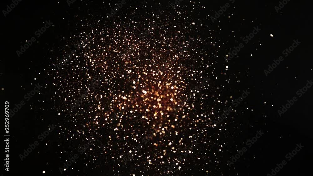 Golden glitter explosion in super slow motion on blacg background. Golden glitter explosion in super slow motion on blacg background.