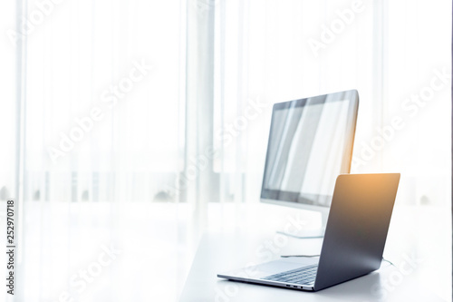 Office workplace with laptop on white table , white office desk  photo