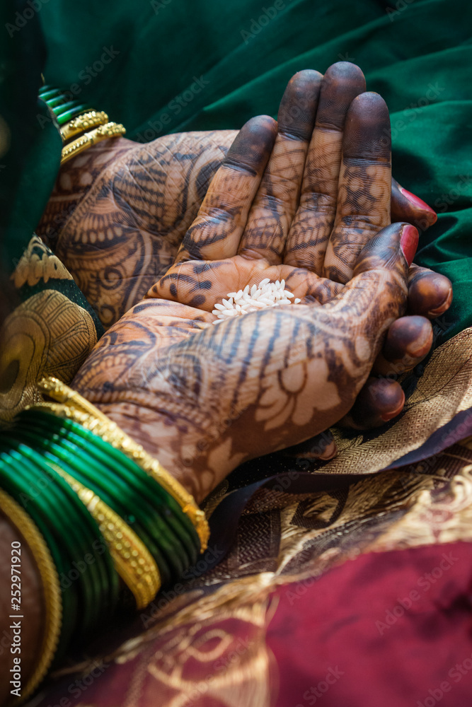 Woman gets traditional mehendi henna decoration for a Hindu wedding