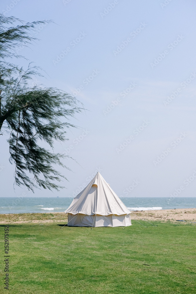 Vintage tent camping on the beautiful beach and clear sky background.