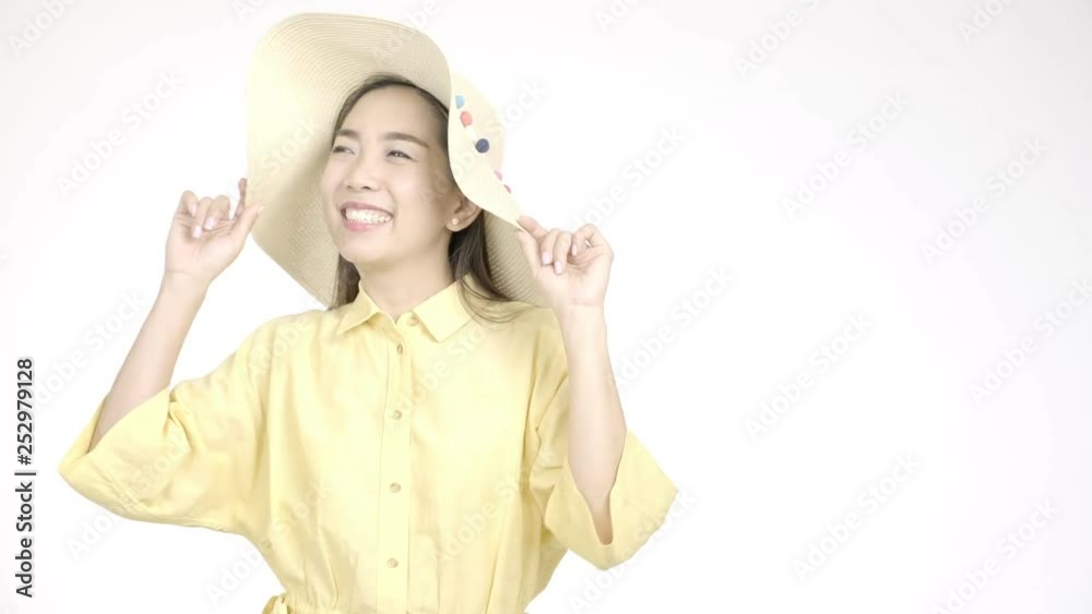 Young beautiful asian woman with summer hat smiling to camera with white background. Holiday lifestyle concept. Young beautiful asian woman with summer hat smiling to camera with white background. Holiday lifestyle concept.