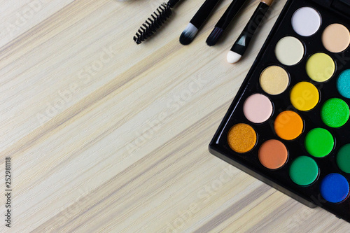 The cosmetic flat lay on wood background..