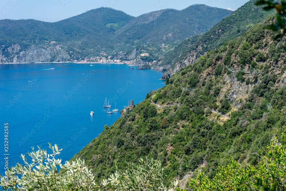 Italy, Cinque Terre, Corniglia, a large body of water with a mountain in the background