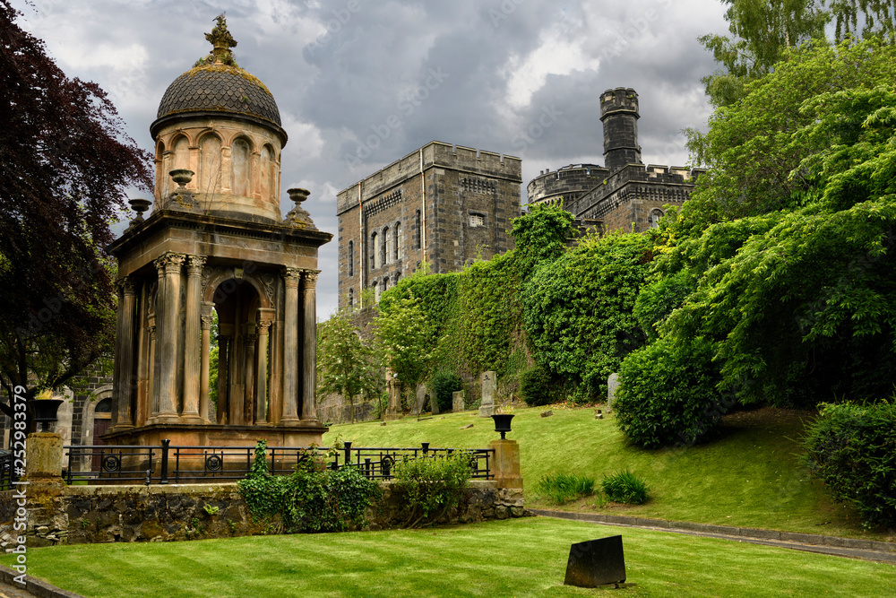 Monument and tomb of Rev Ebenezer Erskine and other gravestones at Stirling Youth Hostel with Old Town Jail in Stirling Scotland UK
