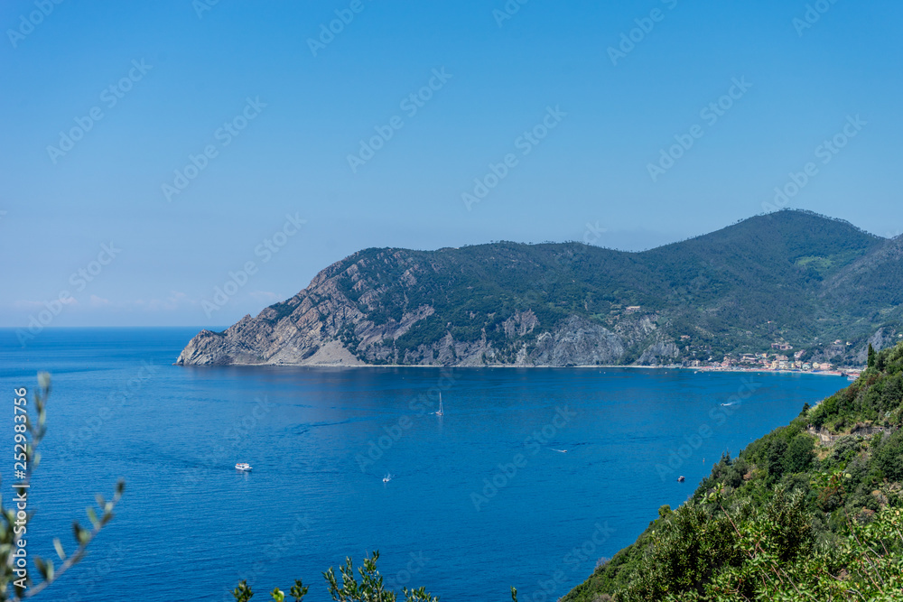 Italy, Cinque Terre, Corniglia, a large body of water with a mountain in the background