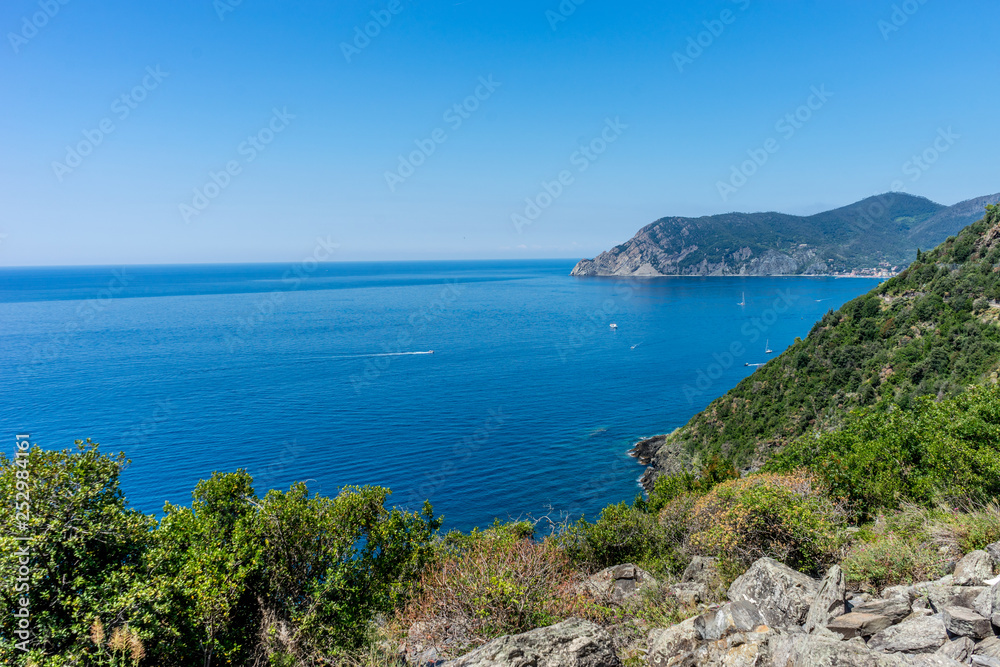 Italy, Cinque Terre, Corniglia, a body of water with a mountain in the background