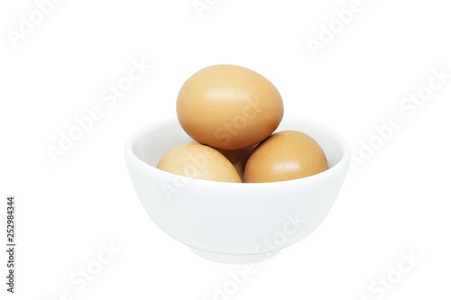 Close up many fresh egg stack in white small bowl isolated on white background.