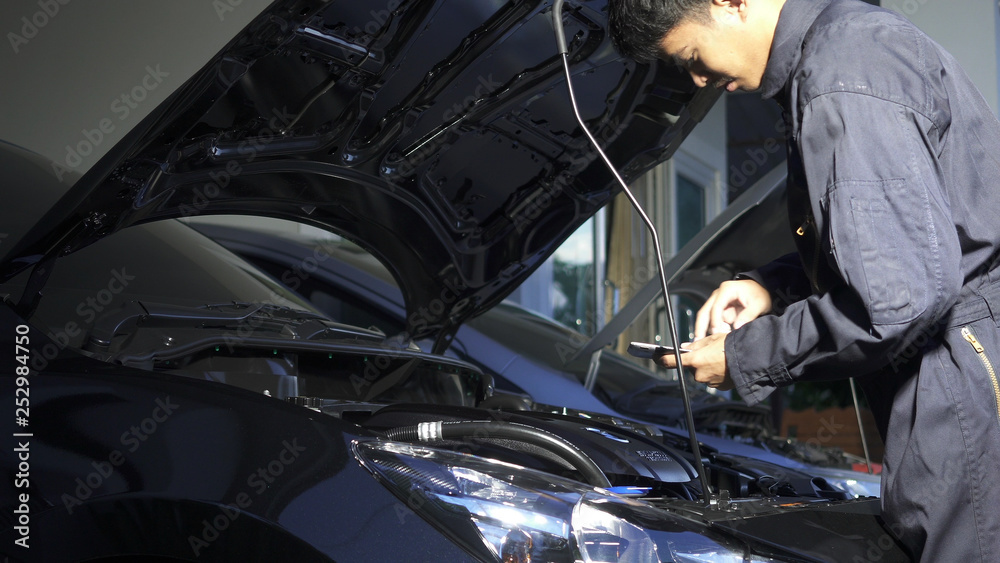 Mechanic man checking, working at workshop car service, repair, car maintenance and people concept. Mechanic man checking, working at workshop car service, repair, car maintenance and people concept.