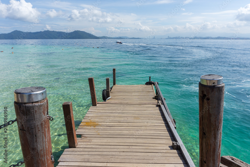 Beautiful wooden jetty with clear blue sky and clear blue sea water