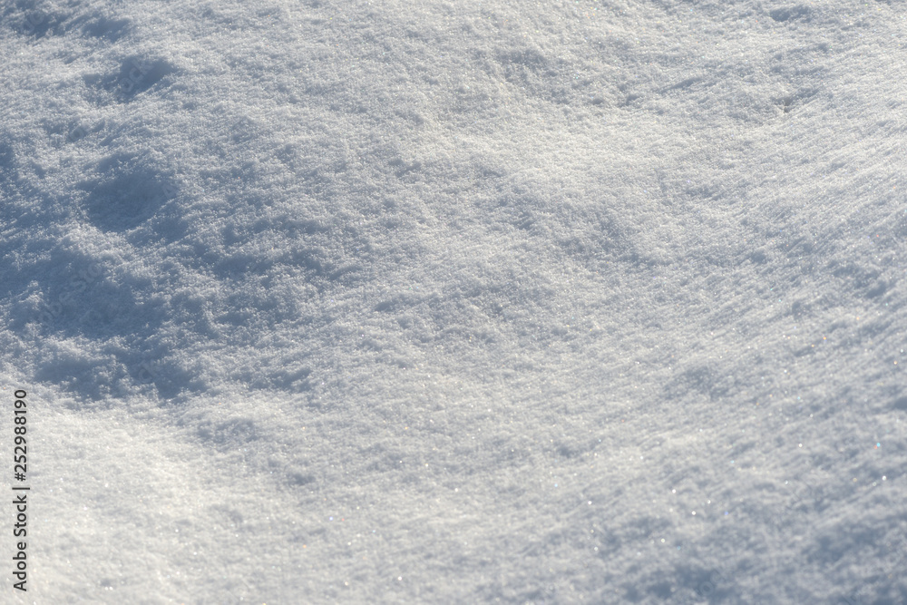 White snow texture on a sunny day. Winter background