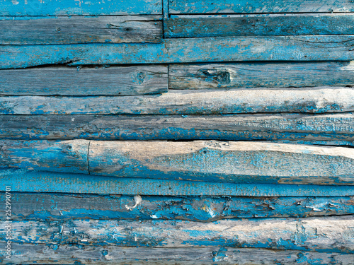 Vintage wood background with peeling blue paint.