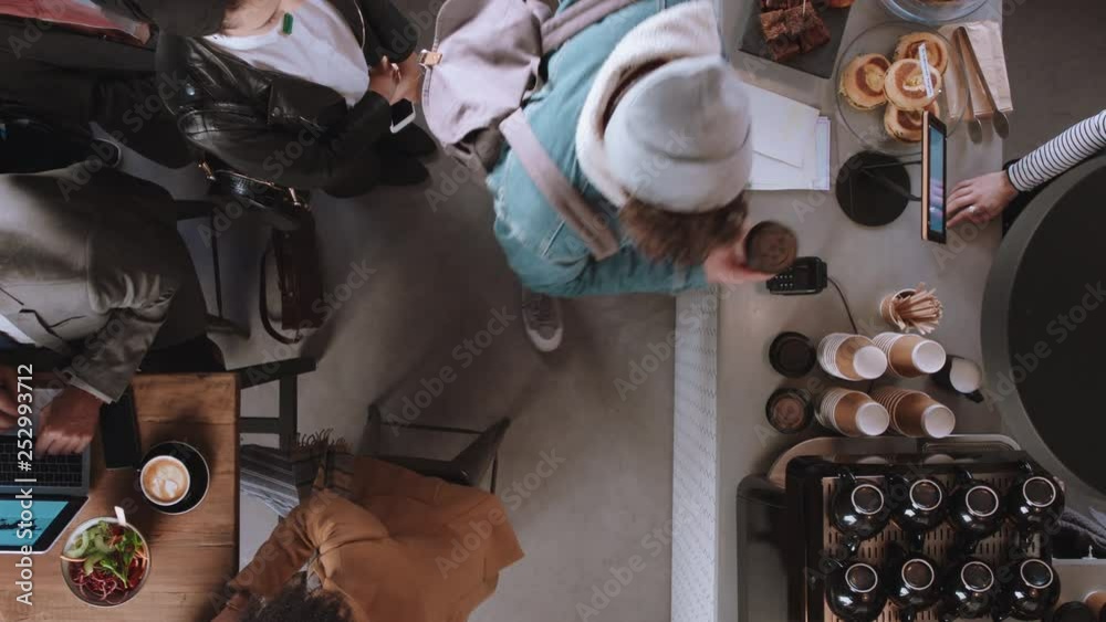 top view customers buying coffee making payment using card machine enjoying service in cafe