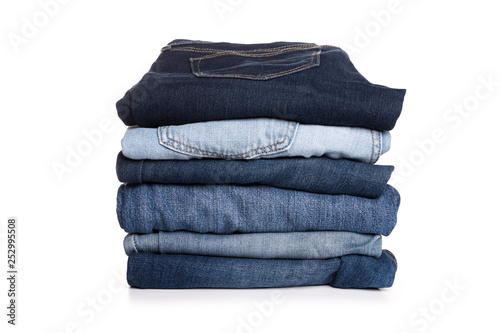 Jeans trousers stack on white background photo