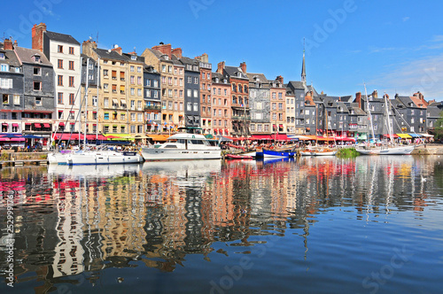 Honfleur harbour in Normandy France. Color houses and their reflection in water.