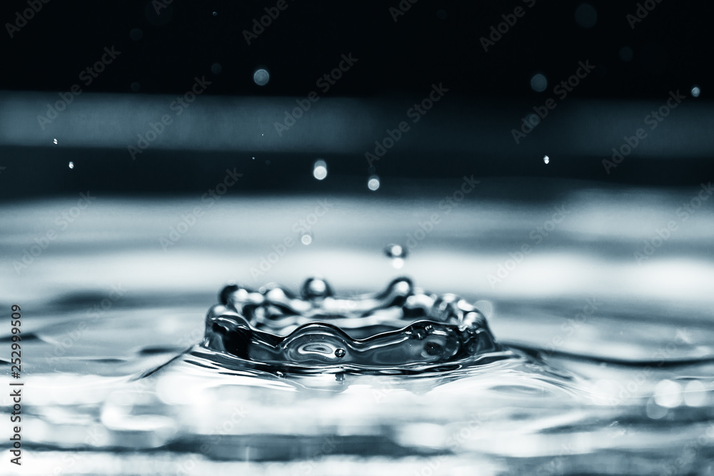 Water droplet splash backgound texture isolated on black. Fresh clean pure water ripples and splashes.  