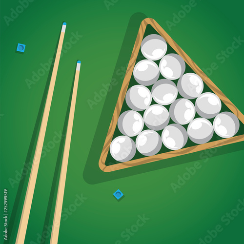 Billiard cue and pool balls in triangle on green table while game. Biliard balls, triangle and pool stick for game on green table top view.