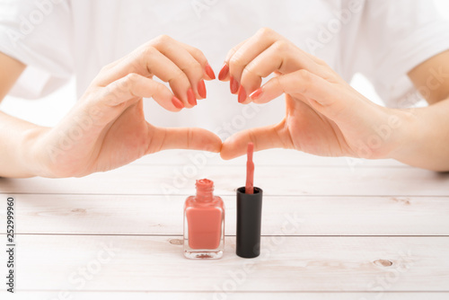 Fototapeta Beautiful women hands perfect red nails doing heart