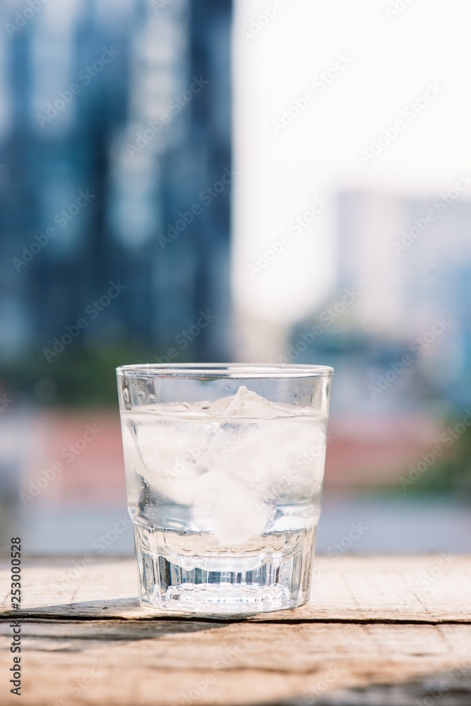 Glasses with ice cubes on wooden table Glasses with ice cubes on wooden table