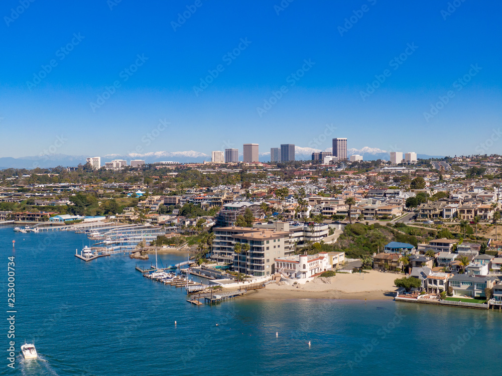 Aerial drone shot of Newport Beach harbor in Orange County California on a sunny day.