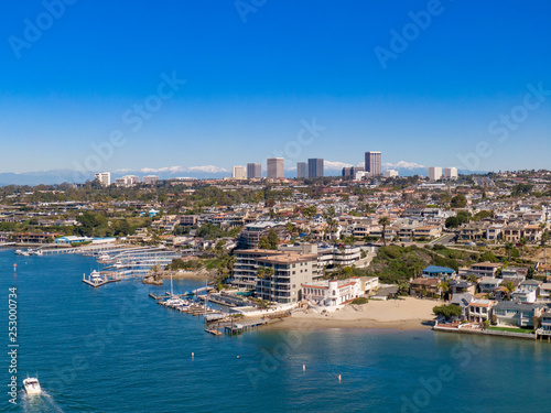Aerial drone shot of Newport Beach harbor in Orange County California on a sunny day.