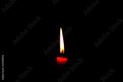 One light flame candle burning brightly on black background