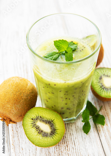 Glass of kiwi smoothie with fresh fruits