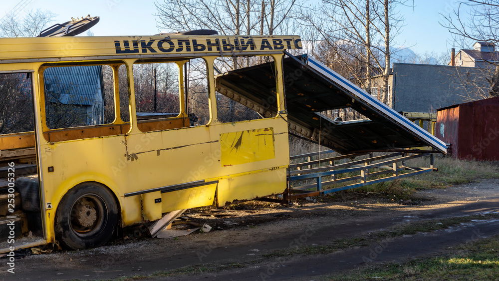 Wreckage bus carcass of yellow school bus in urban wasteland Wreckage bus carcass of yellow school bus in urban wasteland