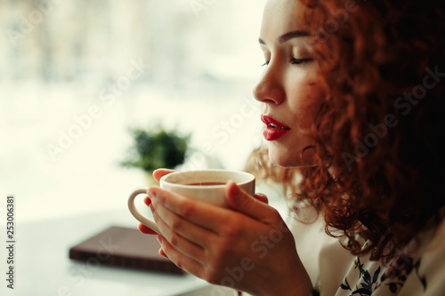 woman in a cafe drinking coffee