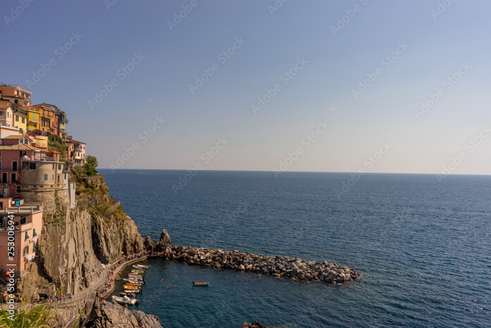 Italy, Cinque Terre, Manarola,PANORAMIC VIEW OF SEA AND BUILDINGS AGAINST CLEAR SKY