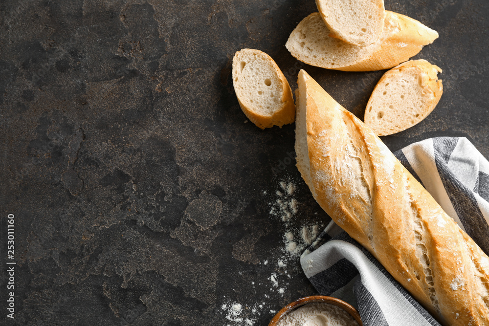 Cut French bread with flour on grey background - obrazy, fototapety, plakaty 