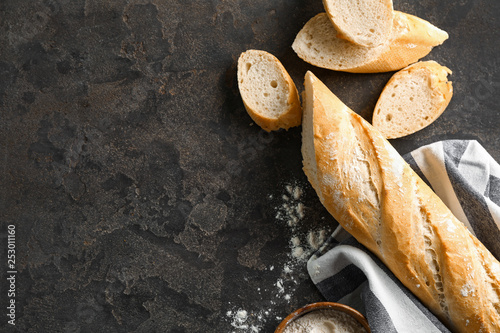 Canvas Cut French bread with flour on grey background