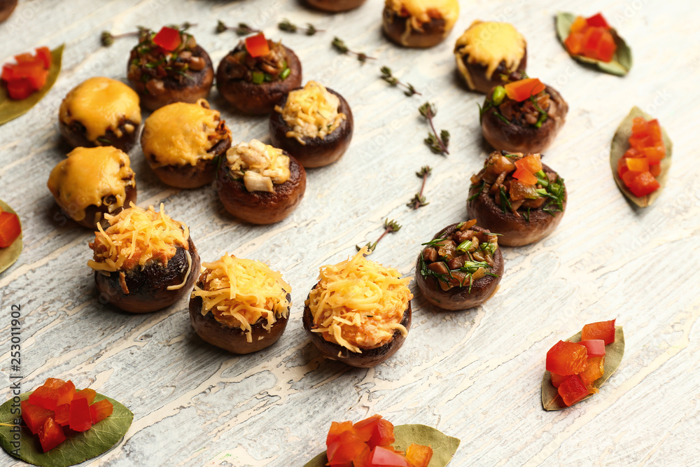 Tasty stuffed mushrooms on light wooden background Tasty stuffed mushrooms on light wooden background